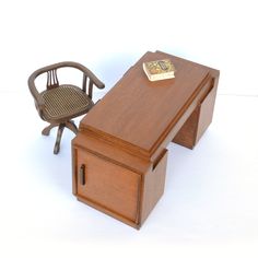 a miniature desk and chair with a gold bar on top