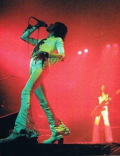 a woman standing on top of a stage holding a microphone