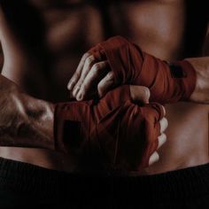 a close up of a person wearing boxing gloves and holding his hands in the other hand