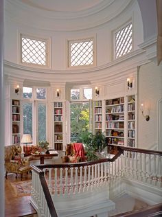 a large room with many bookshelves and chairs on the second floor is shown