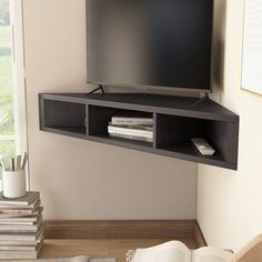 a flat screen tv mounted to the side of a wall next to a book shelf