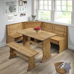 a corner table with benches and a basket of fruit on the floor next to it