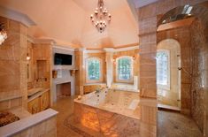 a large bathroom with an enormous tub and chandelier