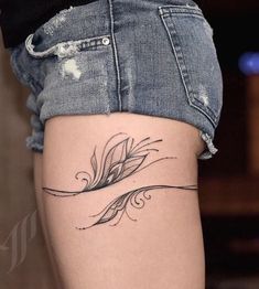 a woman's thigh with a tattoo design on the lower part of her leg