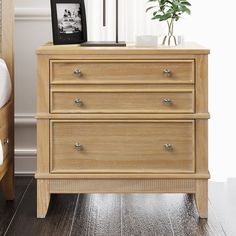 a wooden dresser sitting next to a bed in a bedroom