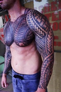 a man with tattoos on his arm and chest