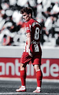 a soccer player is standing on the field