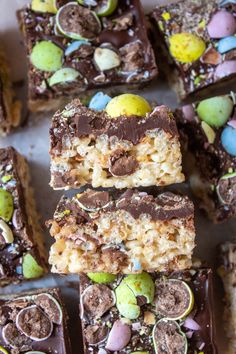 chocolate easter egg rice krispy treats are arranged on a sheet of parchment paper, ready to be eaten