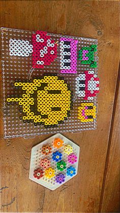 the bead art project is made with beads and plastic pegs to make it look like