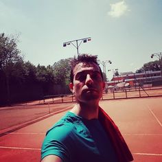 a man taking a selfie on a tennis court