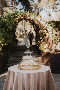 a table with a cake on it and a couple in the background standing next to each other