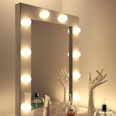 a lighted vanity mirror sitting on top of a table