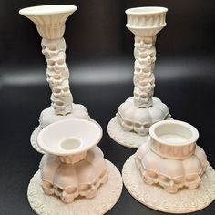 two white candlesticks sitting on top of each other