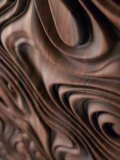 an abstract background made up of wavy lines and curves in shades of brown, beige and black