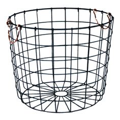 a black wire basket with copper handles on a white background and an orange cord hanging from the bottom