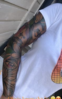 a man with tattoos on his arm and shoulder