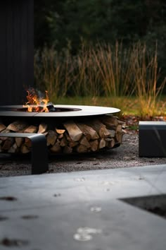 a fire pit sitting on top of a pile of wood