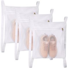 three clear bags with two pairs of shoes in them