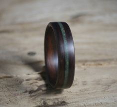 a wooden ring sitting on top of a piece of plywood with a green stripe in the center