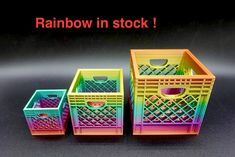 three plastic baskets with different colors and patterns on them, one is rainbow in stock