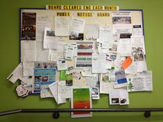 the bulletin board is covered with papers and other things that are posted on it's side