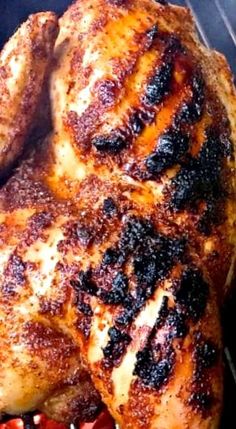 a close up of a chicken on a grill