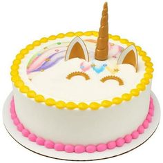 a birthday cake decorated with an unicorn face