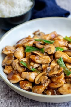 chinese chicken and mushroom in a white bowl