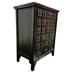 an old wooden cabinet with many drawers and knobs on the doors is isolated against a white background