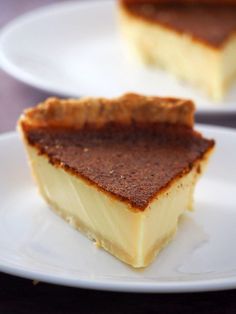 two pieces of dessert sitting on top of white plates