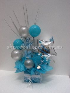 a vase filled with blue and silver balloons