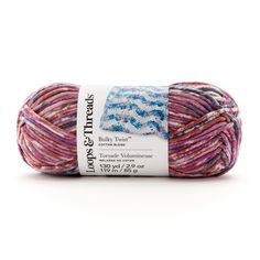 a ball of yarn with blue and pink stripes on the top, in front of a white