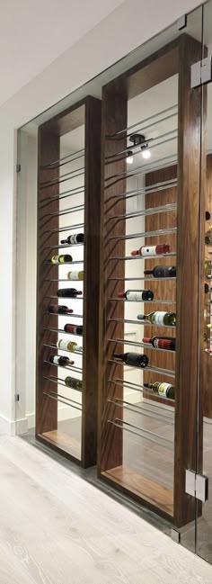 a wine cellar with glass doors and wooden shelves