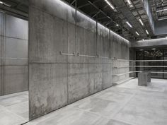 an empty room with concrete walls and metal bars