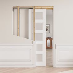 an open door leading to a white room with wooden floors and walls in the background