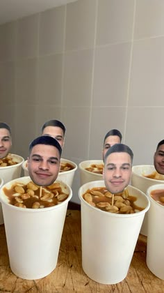 a group of men sitting in white cups filled with food