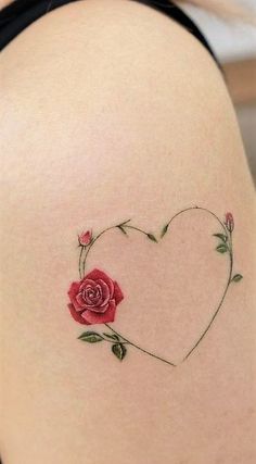 a woman's thigh with a rose tattoo on it