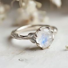 **Make a sparkling statement with this natural inspired Moonstone Engagement Ring at your next event. It's crafted in sterling silver, Gold/White Gold/Rose Gold bands. This ring is beautifully decorated with genuine Moonstones.  Gem: Oval Moonstone 8mm-11mm  *This is a listing for one Moonstone Engagement Ring. We will carefully select a stone and make the piece for you.  Keep in mind, every piece we create is one-of-kind, with raw stones that differ in size, shape, and color. When ordering, ant Moonstone And Diamond Engagement Ring, Engagement Ring No Stone, Gemstone Silver Ring, Simple Unique Engagement Rings Silver, Vintage Moonstone Engagement Rings, Silver Moonstone Ring, White Moonstone Ring, Engagement Rings Silver Unique, Engagement Rings Moonstone