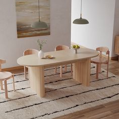 a dining room table and chairs with a rug on the floor in front of it