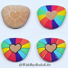 four colorful rocks with hearts painted on them