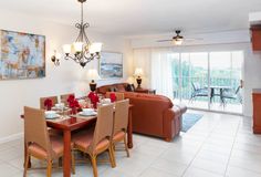 a living room and dining area with tile flooring