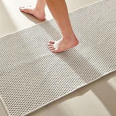 a person standing on top of a white mat