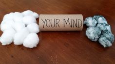 two balls of yarn next to a roll of paper that says your mind