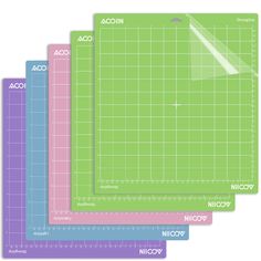 three cutting mats with different sizes and colors on each side, one has a ruler in the