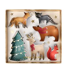 an assortment of christmas decorations in a wooden box