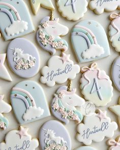 decorated cookies with unicorns, clouds and stars are arranged on a white tablecloth