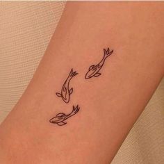 two fish tattoo on the ankle