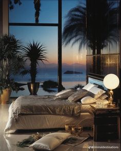 a bedroom with an ocean view is shown in this image, it appears to be empty