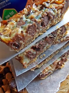 three pieces of chocolate and nuts bar sitting on top of each other