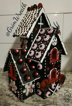 a black and white house with red decorations on it